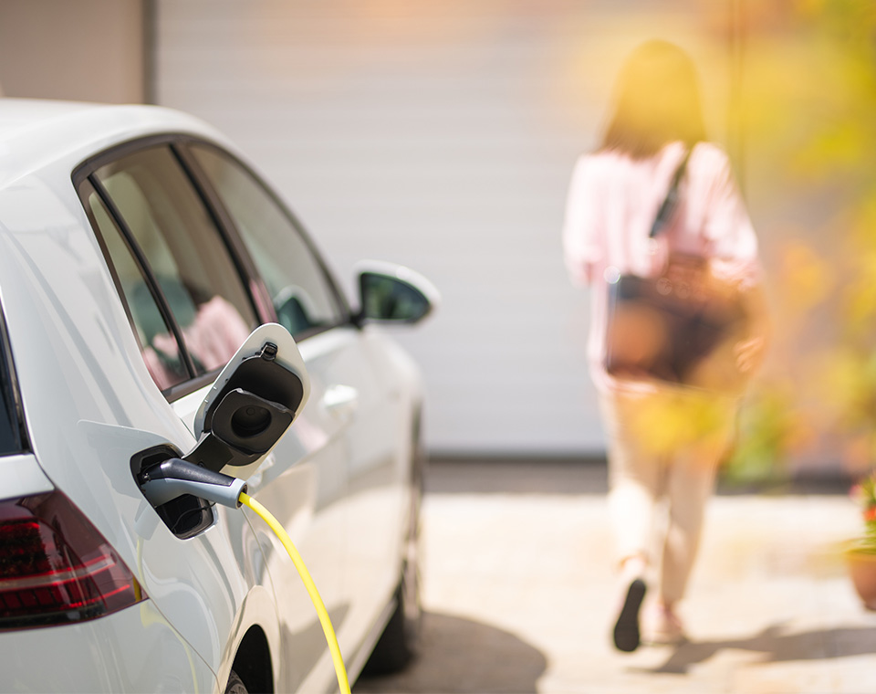 ev getting charged on a home driveway